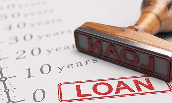 Picture of a rubber stamp with the word LOAN on a chart listing numbers of years