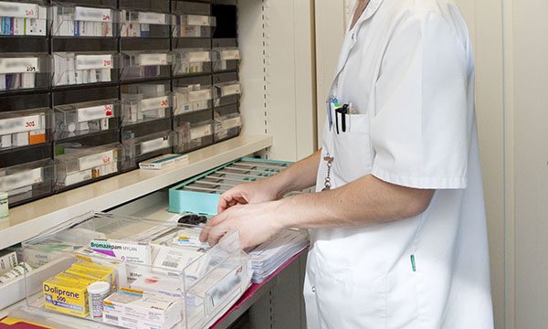 Picture shows a nurse preparing a drugs trolley