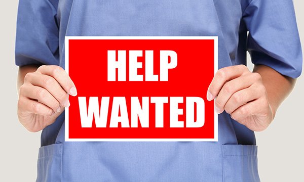 Nurses holds sign saying 'help wanted' as NHS leaders reveal staffing worries