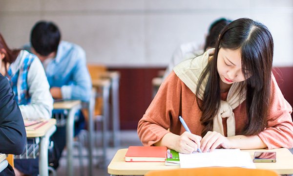 students sit a written exam