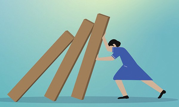 Image of a nurse trying to prop up a line of collapsing columns