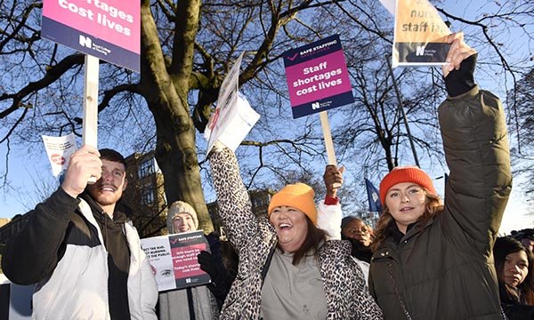 Nurses acknowledge support from passing motorists on the picket line outside Bradford Royal Infirmary