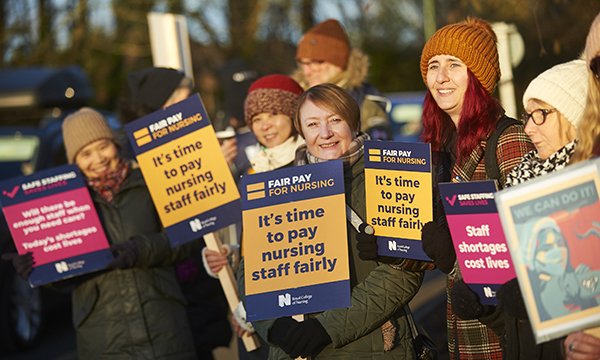 Striking nurses on the picket line with placards for fair pay at the University Hospital of North Durham