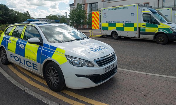 Police car parked in front of hospital ED as figures show high volume of police call-outs in response to violent incidents in the NHS