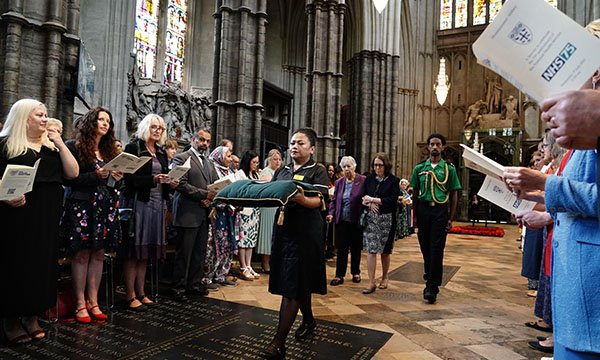 Nurse May Parsons carrying the George Cross at the start of the service at Westminster Abbey