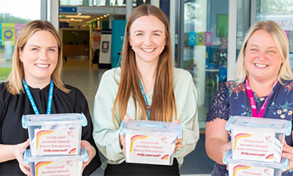 Photo of staff with free period packs at The Robert Jones and Agnes Hunt Orthopaedic Hospital