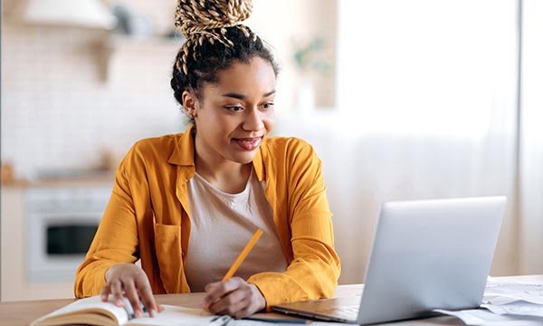 Young woman works on laptop – to illustrate RCN Foundation education grant scheme for nurses