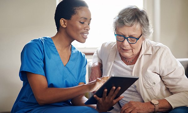  A nurse talks a patient through treatment and trial options relating to cancer drugs