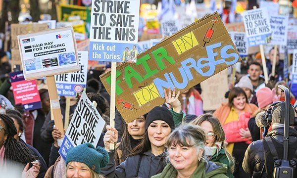 Nurses march with banners calling for better NHS pay