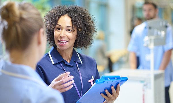 Photo of nurse supervising a support worker