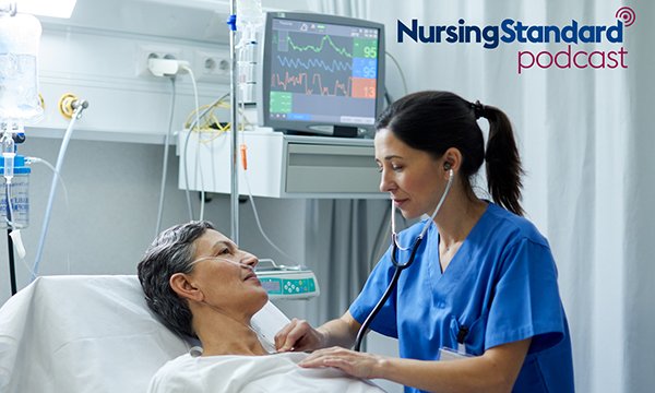 A medic examines a patient lying in a hospital bed