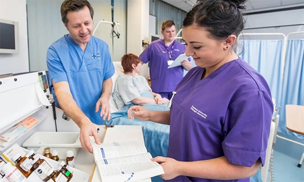 Nurses preparing medicines in a hospital ward