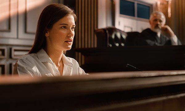 Photo of woman giving evidence in a courtroom