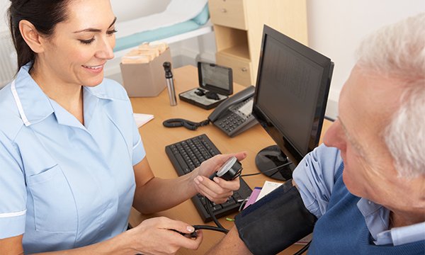 Photo of general practice nurse with a patient, illustrating story about nurses' addition to a work scheme