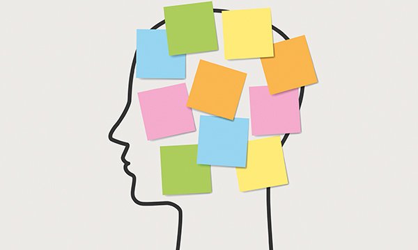 Outline of a human head with sticky notes in different colours attached to it, suggesting the labels some nursing staff apply to others