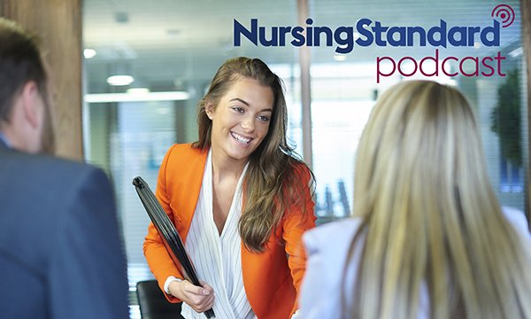 Smiling woman greeting an interview panel