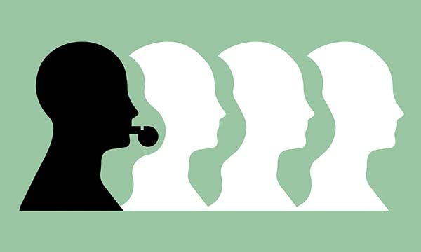 An illustration showing four outlines of heads looking to the right, on a green background. The one on the left is blowing a whistle and stands out from the rest as it is coloured black, while the others are white