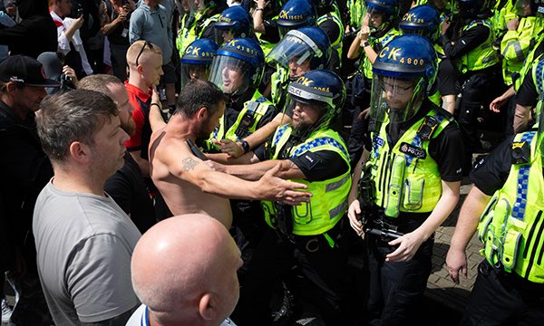 Rioters clashing with police in Manchester. Nurses are being advised on withdrawing treatment from racist or violent patients.