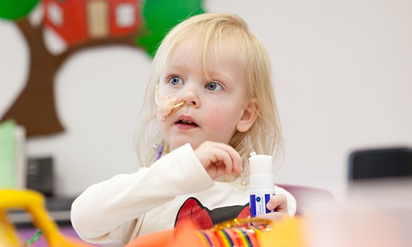 A small girl wearing a nasogastric tube. A revised approach for checking the position of nasogastric tubes that would enable more children to remain at home