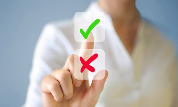 RCN is asking nursing staff in an online consultation to say if they approve or disapprove of a pay award of 5.5%; picture shows a finger touching a tick mark on a screen