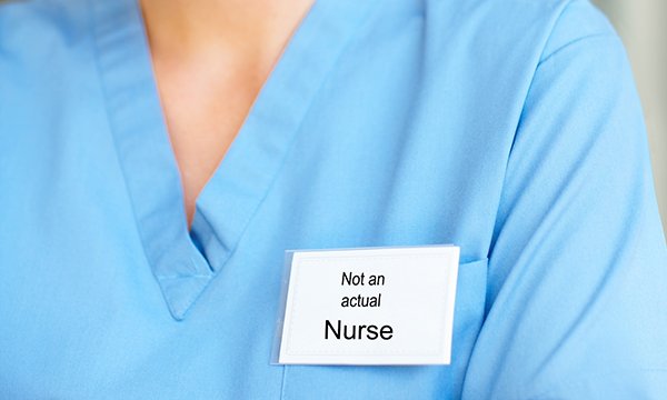 NHS support staff can have job titles that suggest they may be registered nurses. Image shows a badge that reads 'not an actual nurse', worn by someone in a blue uniform