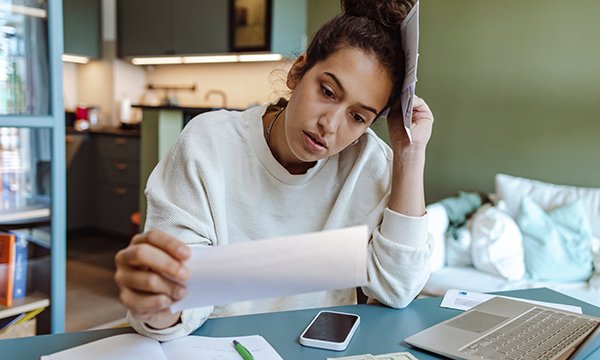A total of 23,800 nursing students have been accepted onto courses across the UK, down by one fifth since the peak in 2021. A stressed student looks at some documents