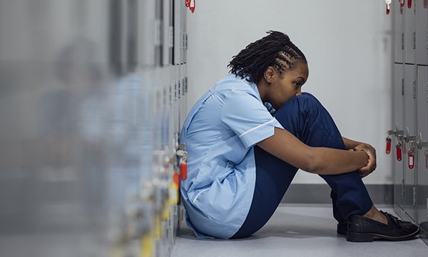 Nurses’ fear of mistakes: a nurse sits on the floor of a locker room trying to overcome her nerves at work