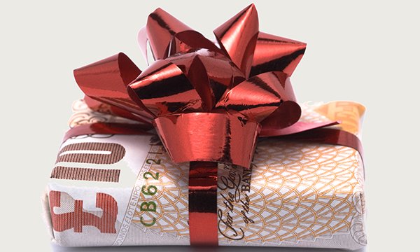 Gifts for nurses from patients: a gift wrapped in a £10 note and topped with a red ribbon, representing the gift of better pay for nurses