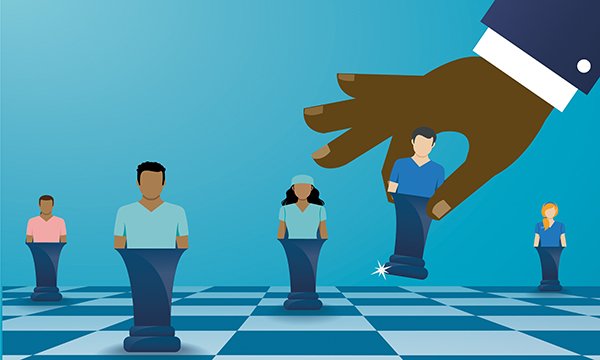 Redeployment in nursing: illustration showing a large hand moving small figures of people around a chess board, suggesting redeploying staff in healthcare settings