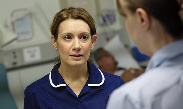 Feedback from nurse manager: a nurse appears taken aback in a conversation with a manager in a clinical setting