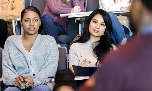 Nursing school closures: students attending a lecture. UK nursing school closures come despite chronic nursing shortage