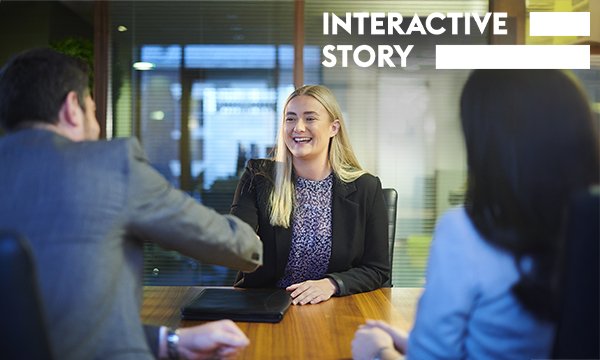 Nursing job interviews: a job interview candidate sitting at a conference table shakes the hand of an interviewer as another looks on