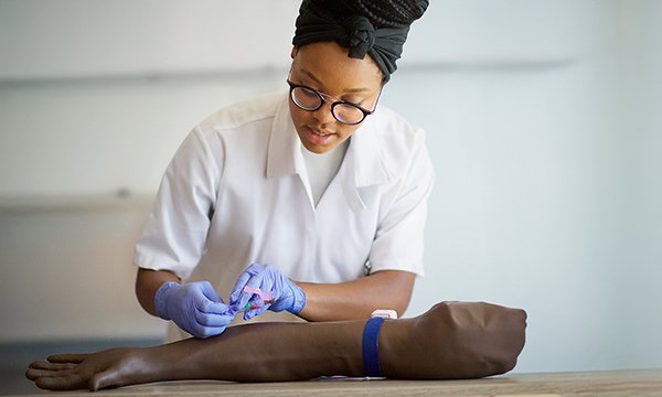 Education grants: a healthcare support worker practises phlebotomy