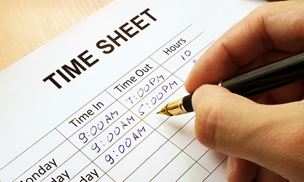 Nurse suspended by NMC: a hand filling in a timesheet