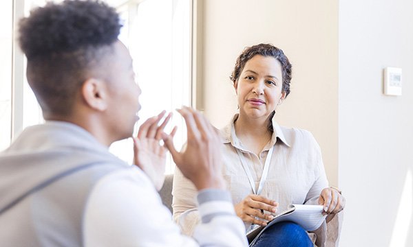 The Mental Health Bill 2025 is reshaping the legal and ethical foundations of mental healthcare in England and continues the shift from hospital to home: a young man talks with a mental health specialist