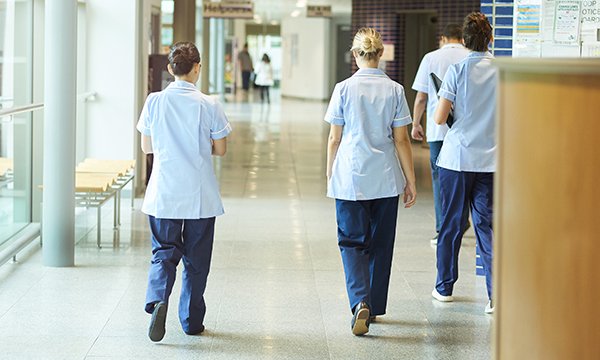 A group of nurses in a hospital corridor. Reasons for leaving include quality of care, flexibility of shift patterns or hours, bullying, harassment or discrimination, burnout and the effect on physical or mental health.