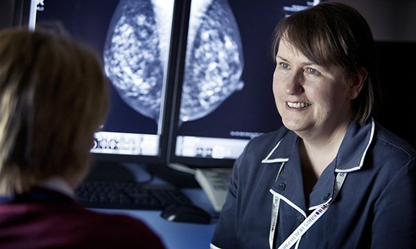 Advanced practice: a nursing practitioner discusses a mammogram with a patient