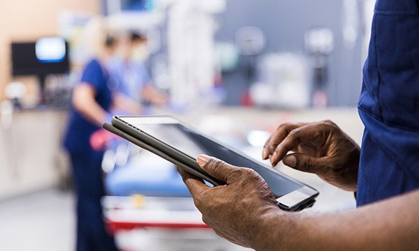 Electronic patient records: a nurse using an electronic pad in a clinical setting