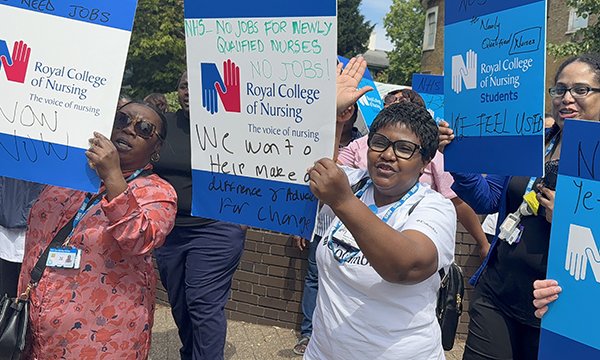 Final-year nursing students hold placards as they protest about the lack of nursing roles outside Croydon University Hospital, south London