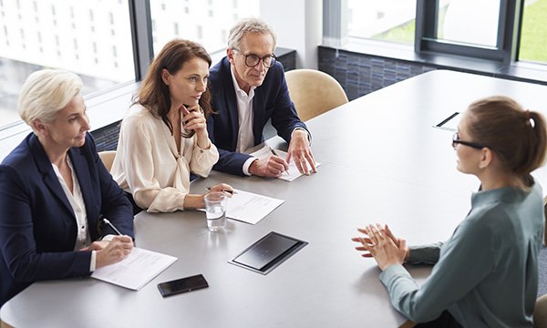 Competency-based job interview: candidate facing a panel of three interviewers