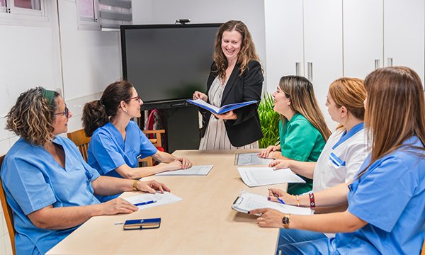 Managerial skillset: a registered manager leads a nursing team meeting 