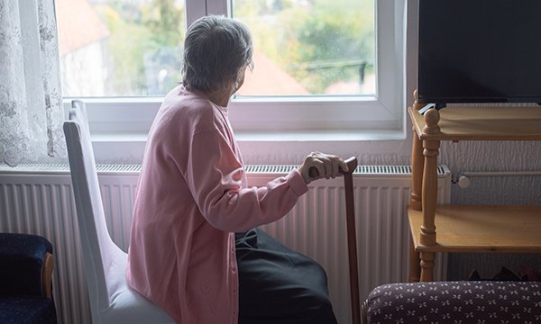 District nurse shortages: an older woman alone and staring out of a window