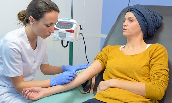 Nurse treating chemotherapy patient