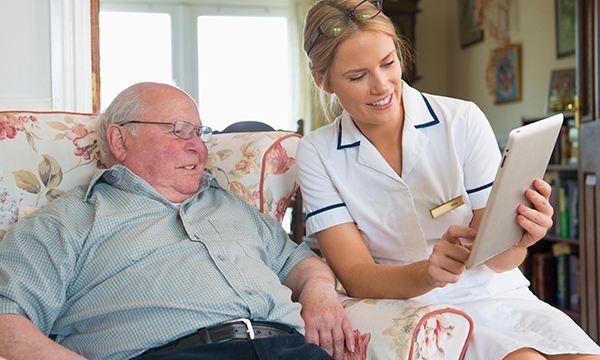nurse and patient view laptop