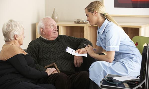 district nurse talks to patient