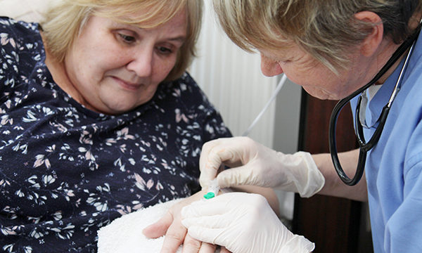 Doctor inserting IV line