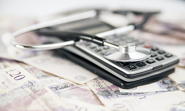 calculator, cash and stethoscope