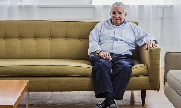 man sitting on sofa