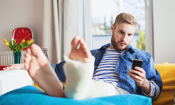 man with plastered foot