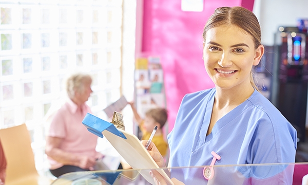 nurse with clip board in waiting area